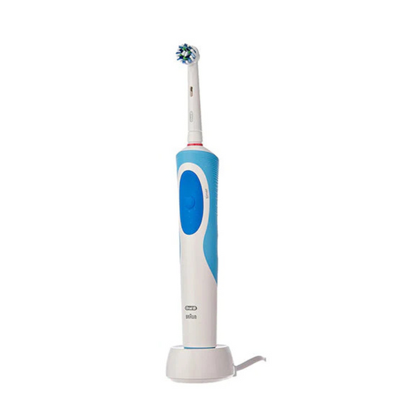 A Braun Oral-B Vitality rechargeable electric toothbrush with a blue and white handle, standing in its charging cradle.