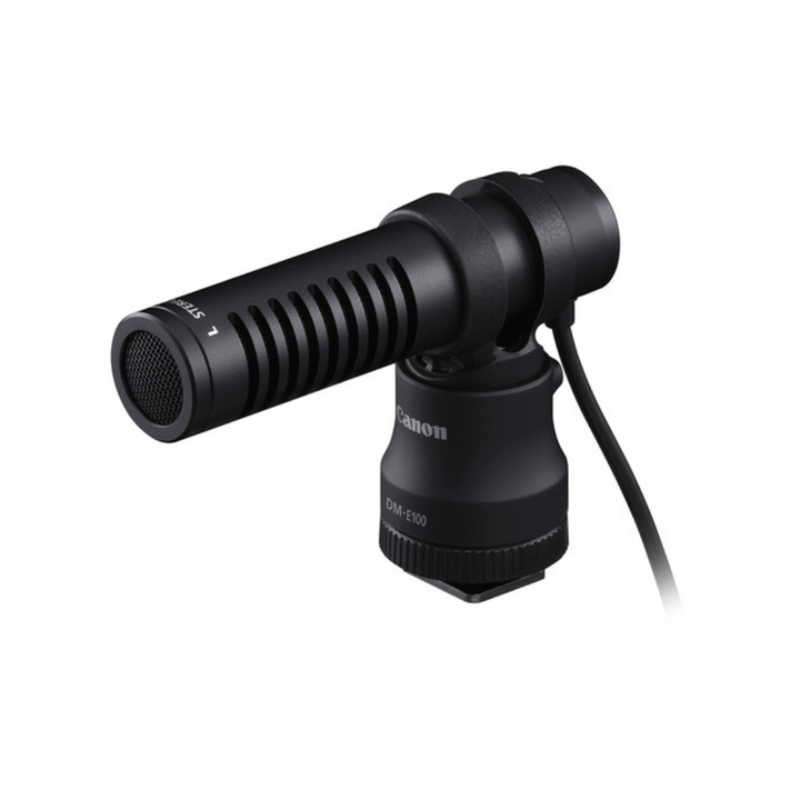 A black Canon DM-E100 shoe-mounted directional microphone with a windscreen and a 3.5mm plug.