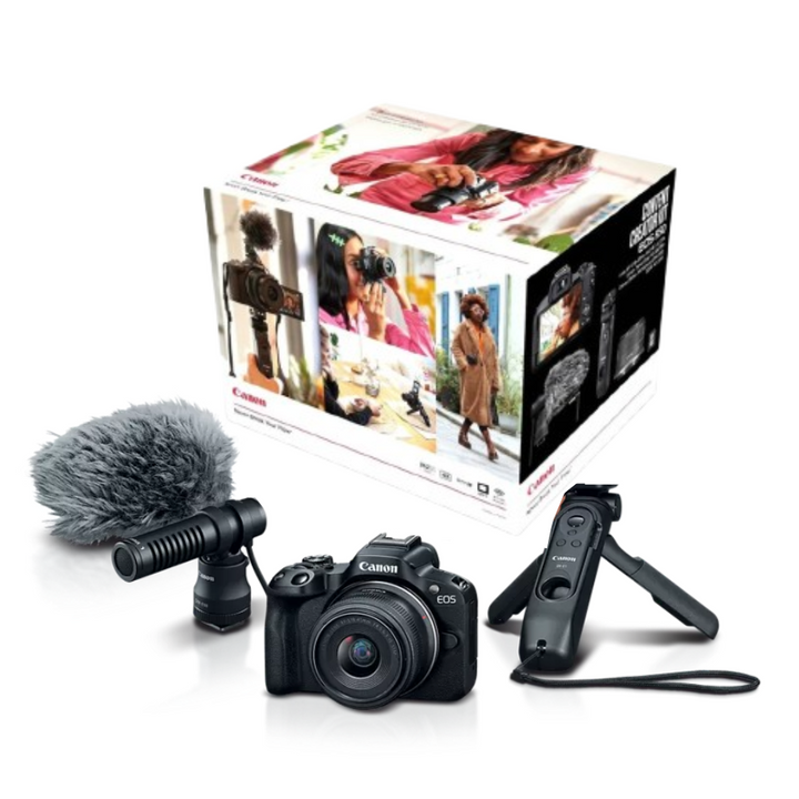 Camera with microphone and remote control in front of a camera equipment box on a white background