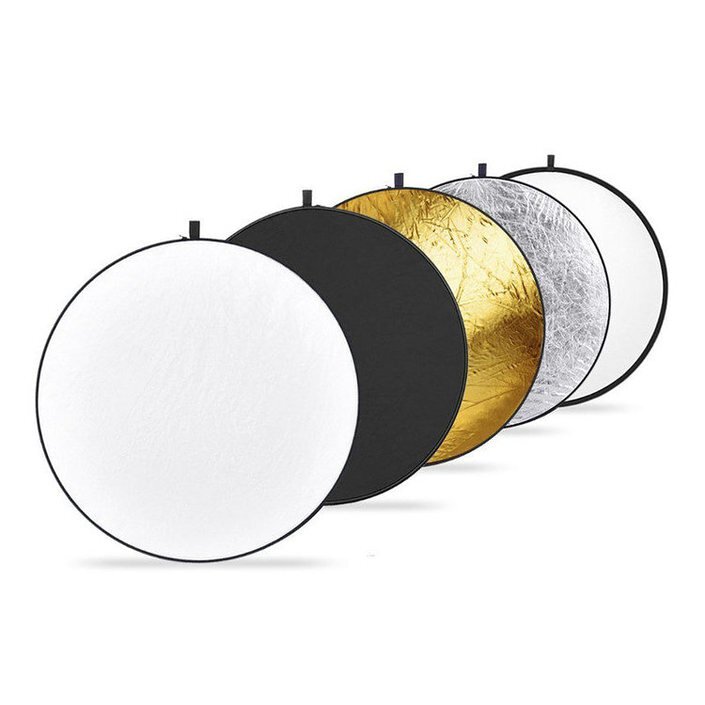 A set of Godox 5-in-1 light reflectors with gold, silver, white, black, and translucent color covers, displayed in a row with zippered carrying pouches.