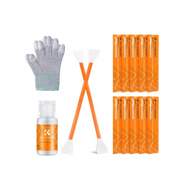 The image shows a camera sensor cleaning kit, including orange cleaning swabs, a bottle of cleaning solution, and a pair of gloves.