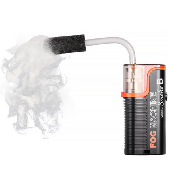 Hand-held smoke machine generating smoke, with visible branding and a black color scheme.