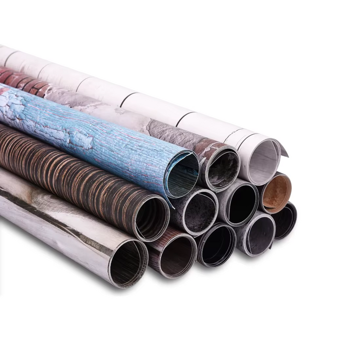 A stack of PVC photography backgrounds in various colors.