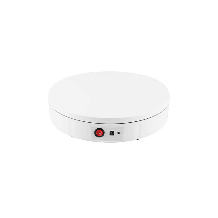 Round white electronic device with buttons on a white background