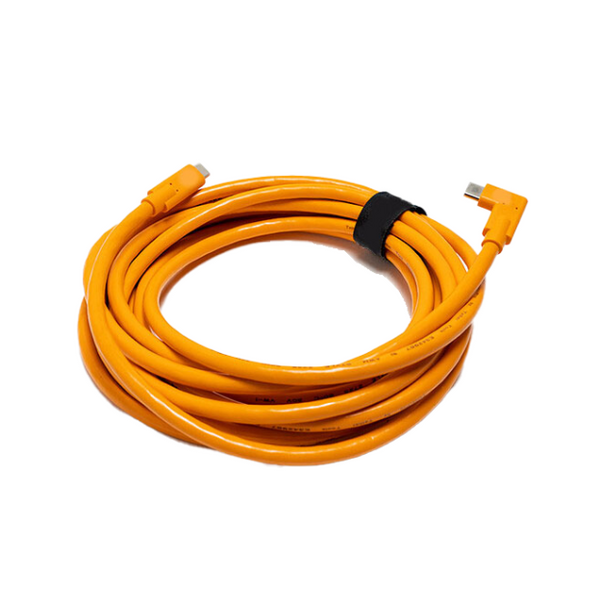 Coiled orange cable with connectors on a white background