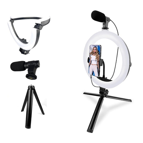 A 10 inch LED ring light kit with a mini table tripod and a microphone. The ring light has a white and black color temperature control knob, and the tripod is black.